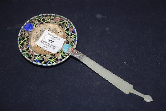 A Chinese white metal and enamel tea strainer, with pierced jade handle, 22cm.